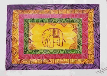 An intricately designed image featuring a stylized elephant in the center, surrounded by vivid geometric patterns. The elephant is adorned with traditional decorative elements. The surrounding patterns consist of repeated arcs and lines, creating a vibrant, dynamic frame of multiple colors.