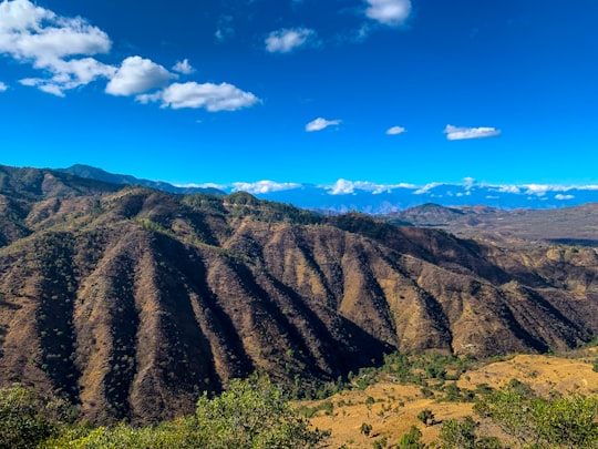 green and brown mountains under blue sky during daytime in Laguna El Jute Guatemala