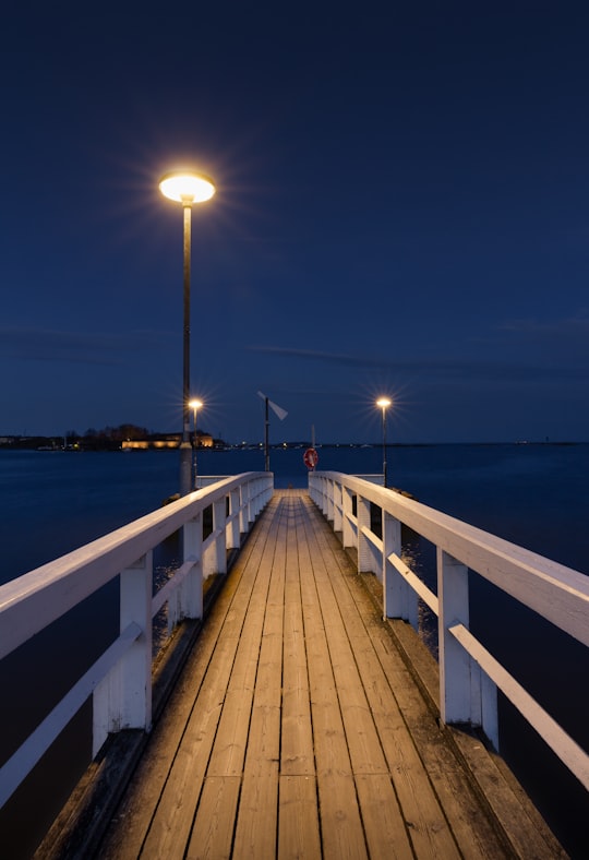 brown wooden dock during night time in Kaivopuisto Finland