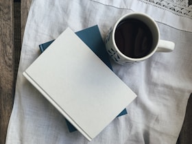white paper beside white ceramic mug