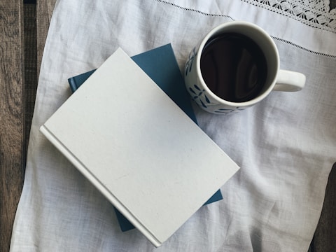 white paper beside white ceramic mug