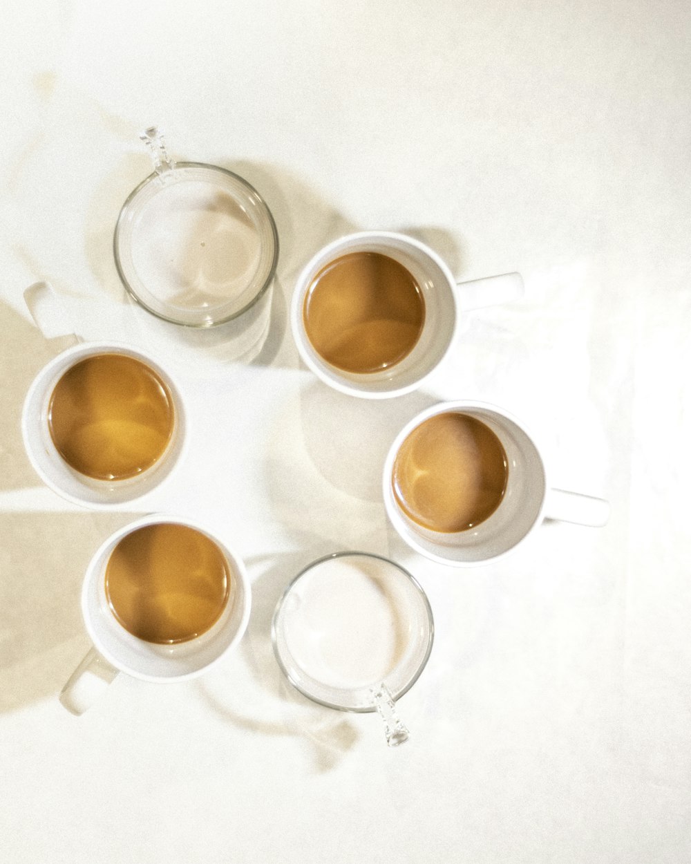 3 white ceramic mugs with brown liquid