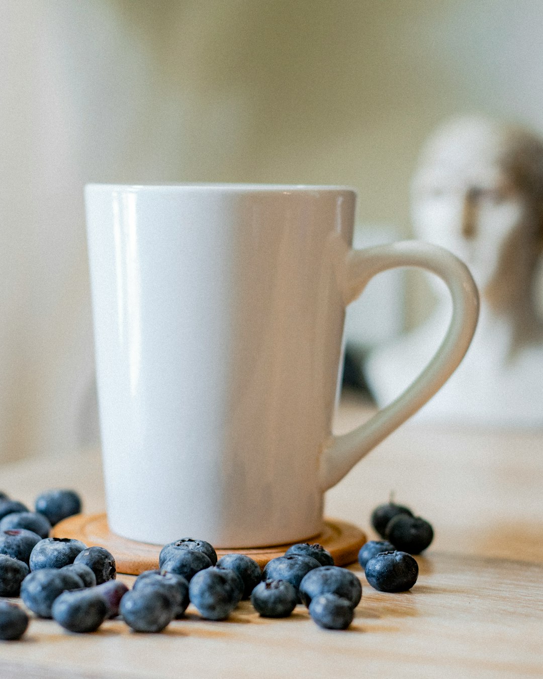 white ceramic mug on blue and white pebbles