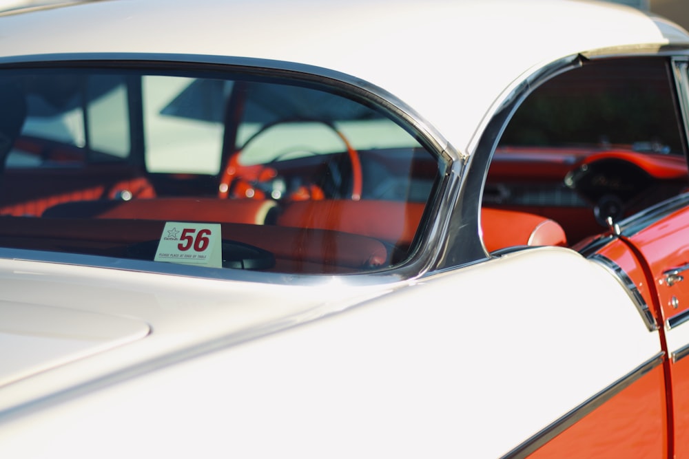 white and red car with black and red car door