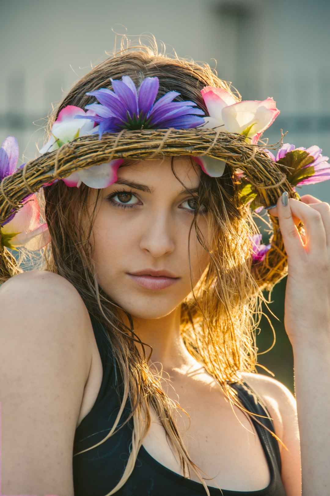 woman in black tank top with white and purple flower crown