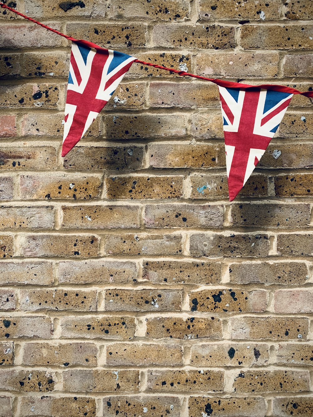 red and white star flag on brown brick wall