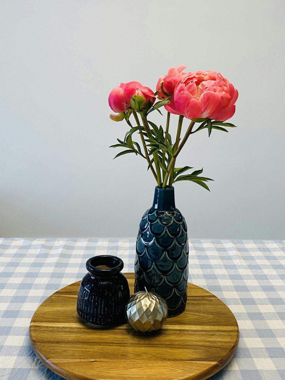 red roses in blue glass vase