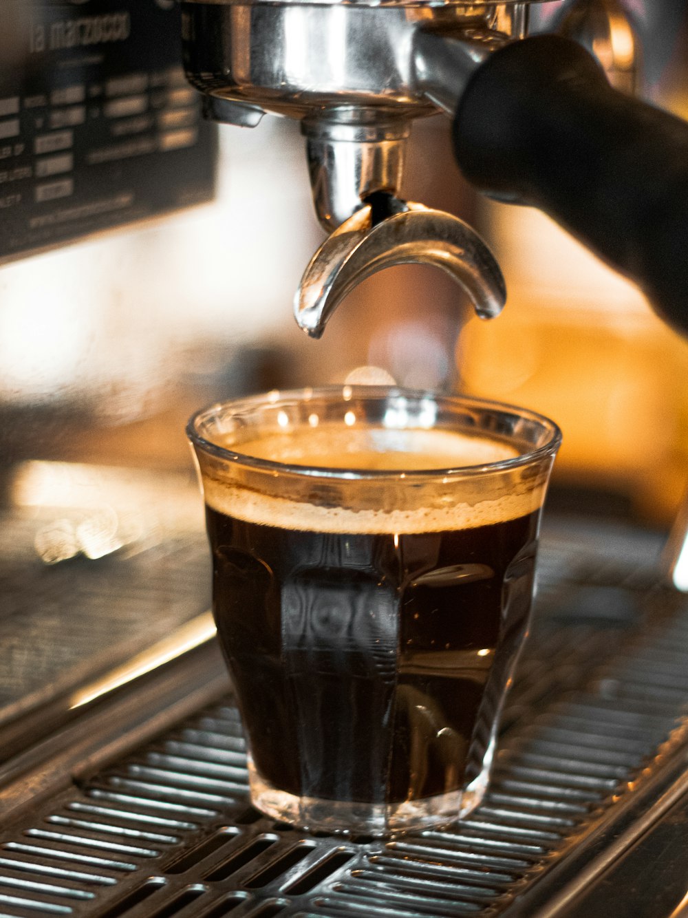 clear drinking glass with brown liquid