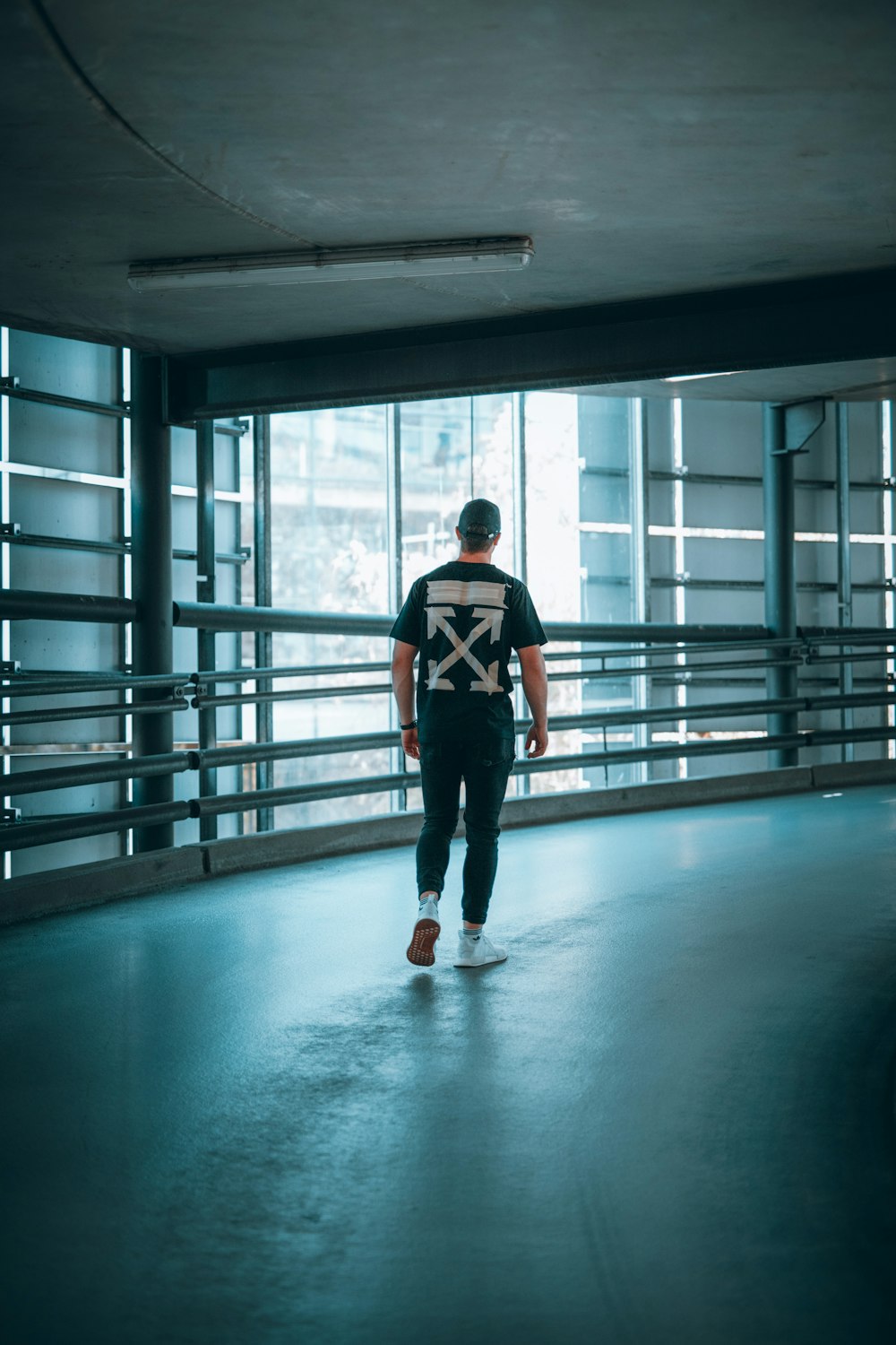 man in black and red jacket standing on white floor