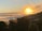 A serene landscape with a sunrise illuminating a peaceful valley.