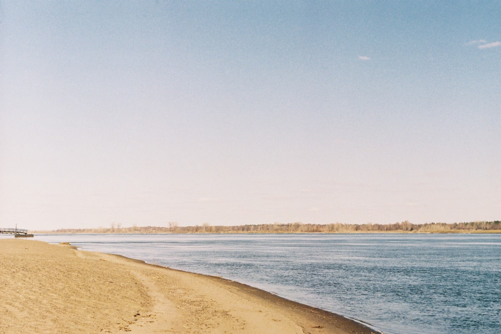 brown sand near body of water during daytime