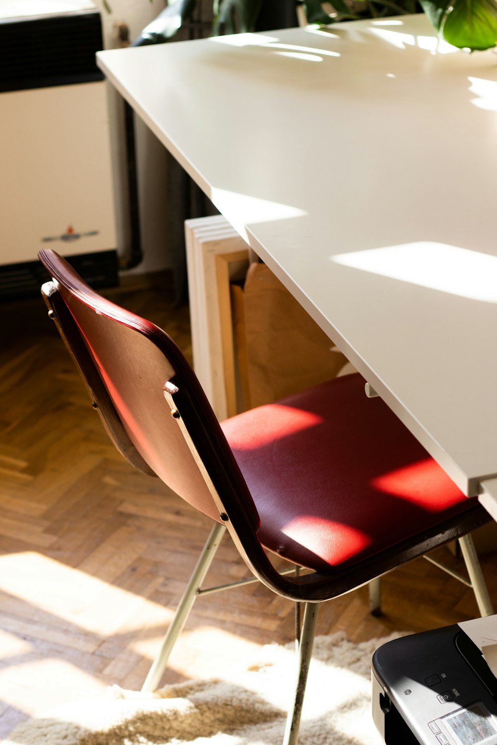 red and gray chair beside white table