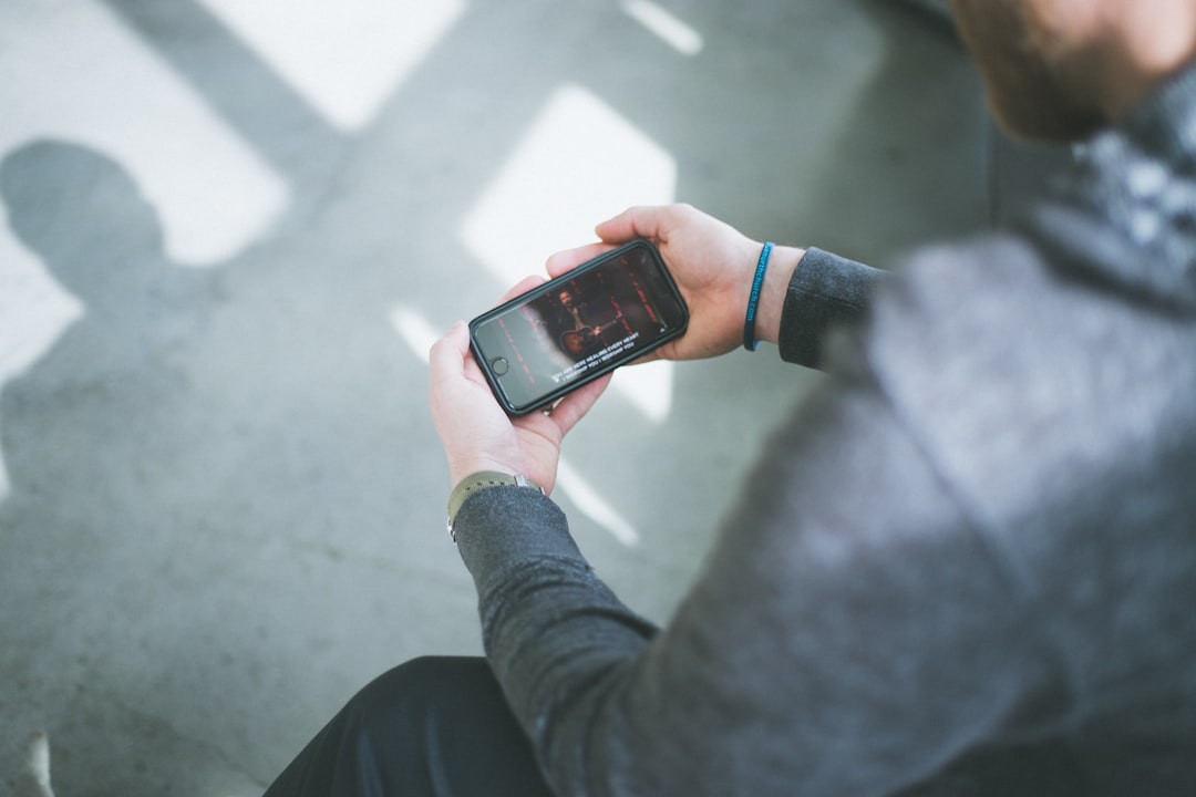 person wearing black and orange smart watch