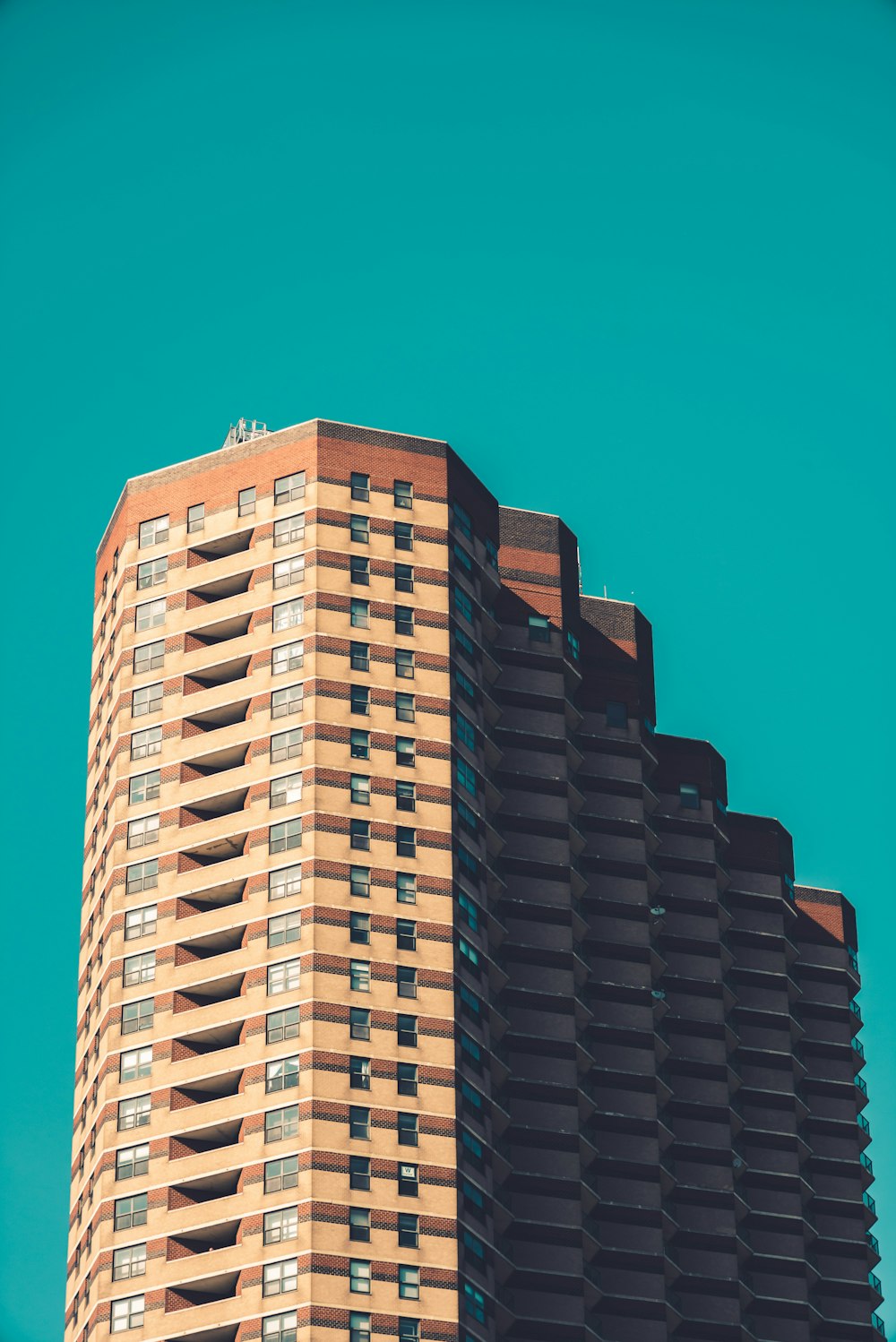 brown and white concrete building under blue sky during daytime