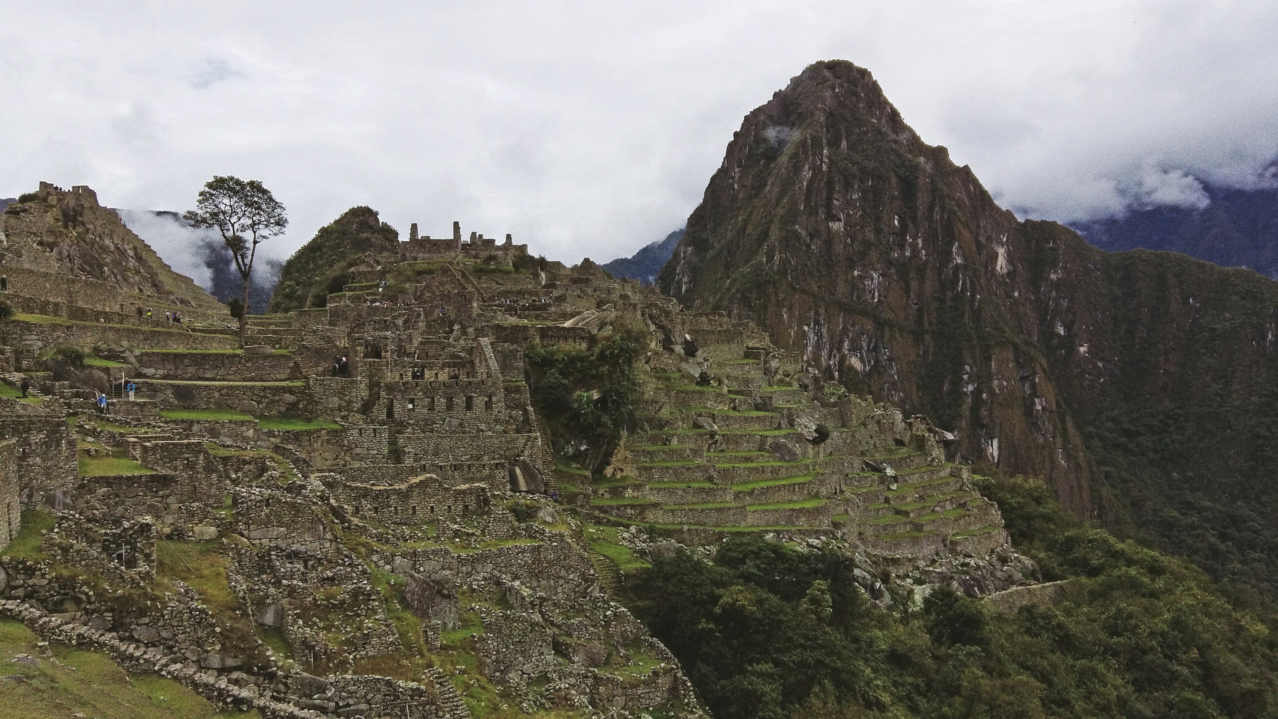 green and brown mountain under white sky during daytime, Machu Picchu on a cloudy morning.