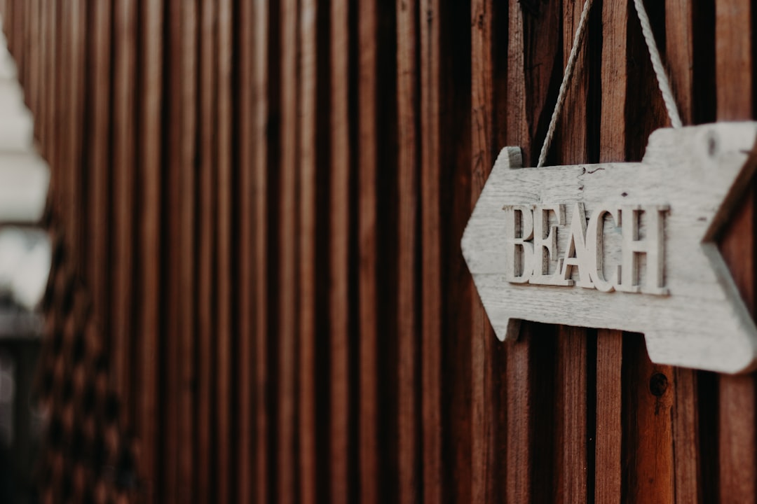 white and black wooden hanging signage