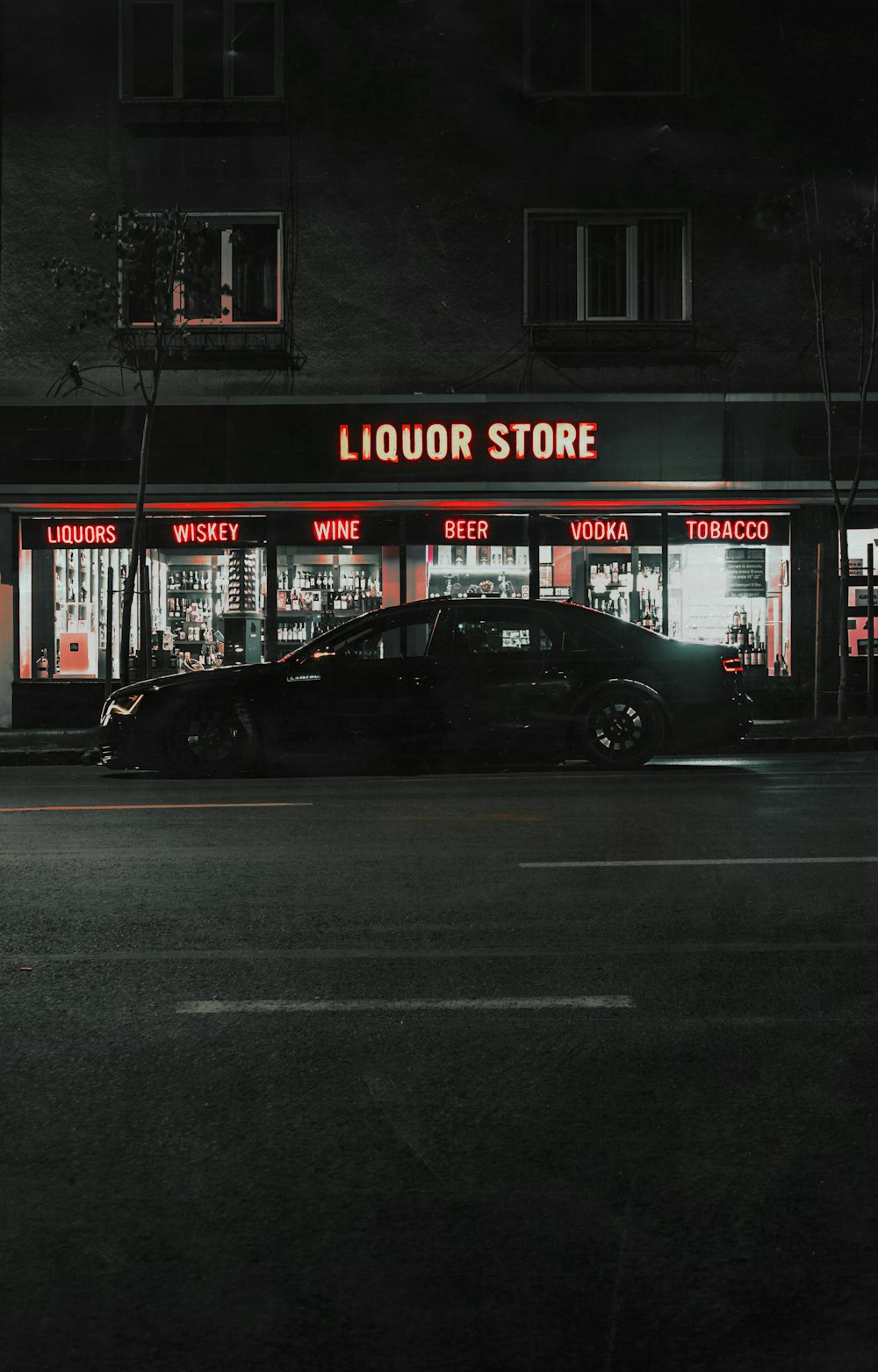 black sedan parked beside the store