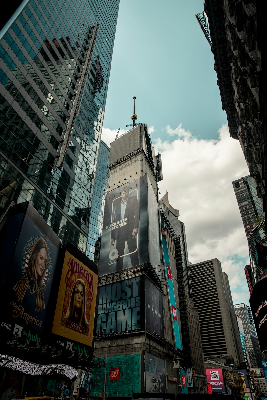 low angle photography of high rise buildings under white clouds during daytime