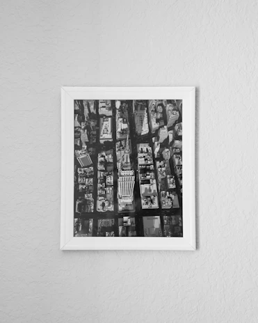 A sleek LED frame illuminating a black-and-white cityscape photo in a modern living room.