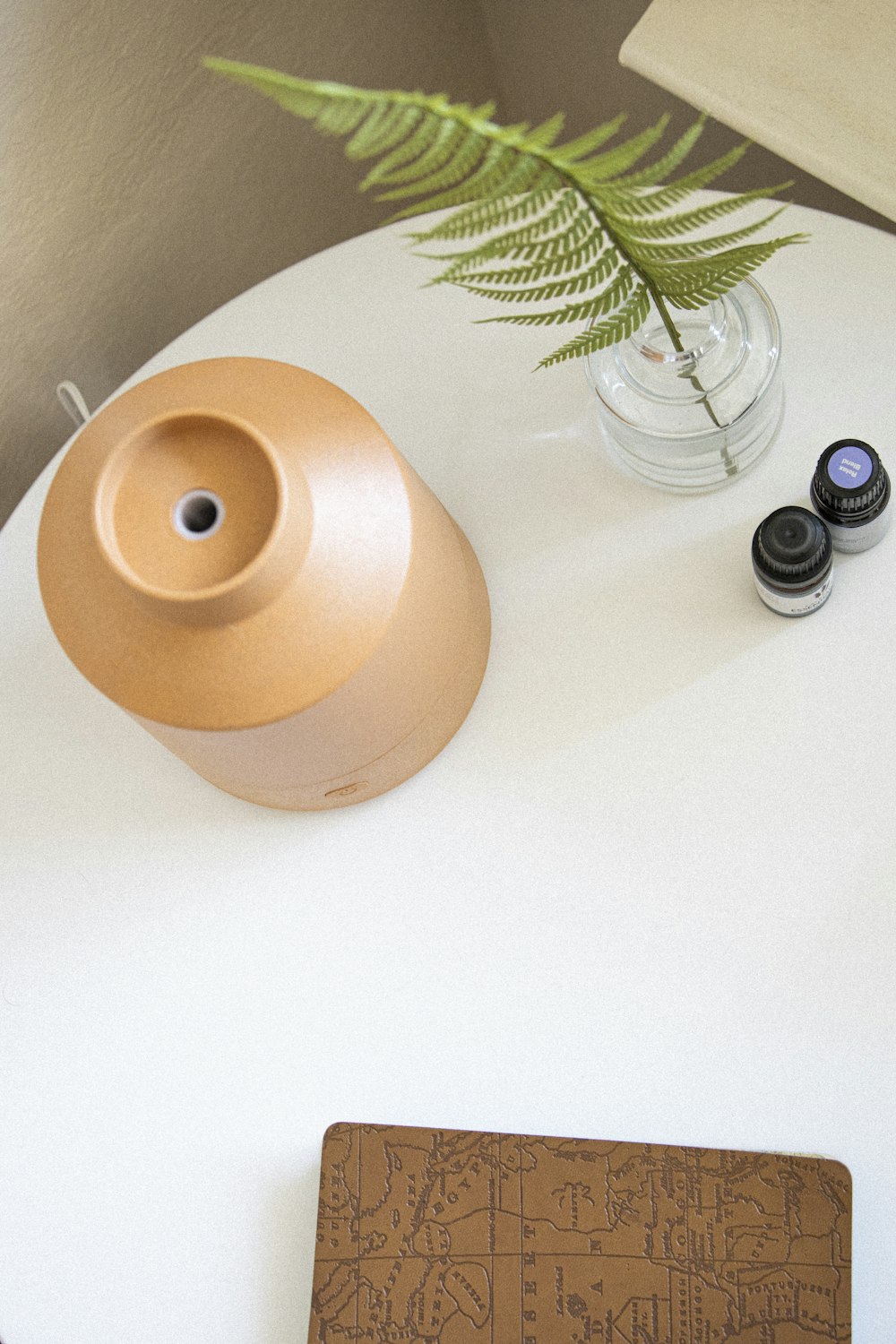 brown round plant pot on white table