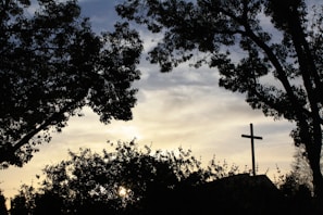 A peaceful sunset with a scripture quote in the foreground.