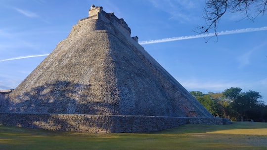 gray concrete building on green grass field during daytime in Pyramid of the Magician Mexico