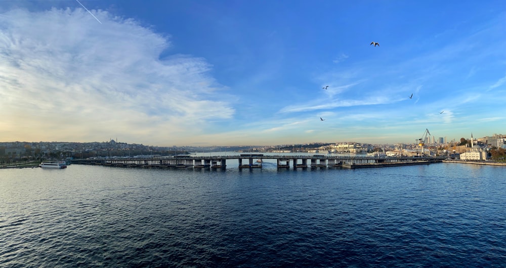 body of water near bridge under blue sky during daytime