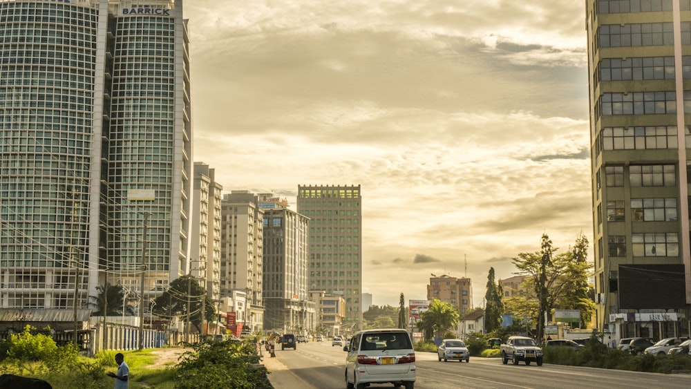 cars on road near high rise buildings during daytime