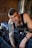 man in black tank top playing guitar