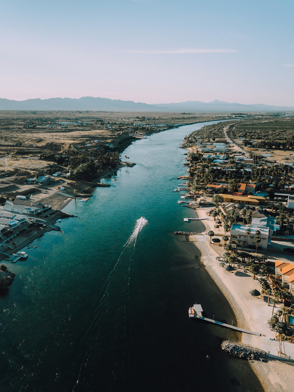 aerial view of city buildings near body of water during daytime