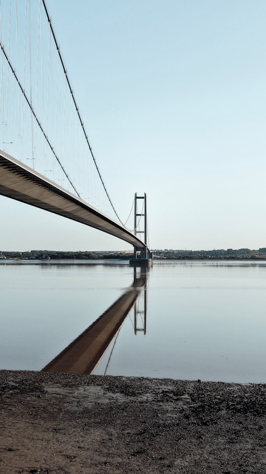 brown bridge over body of water during daytime in The Humber Bridge United Kingdom