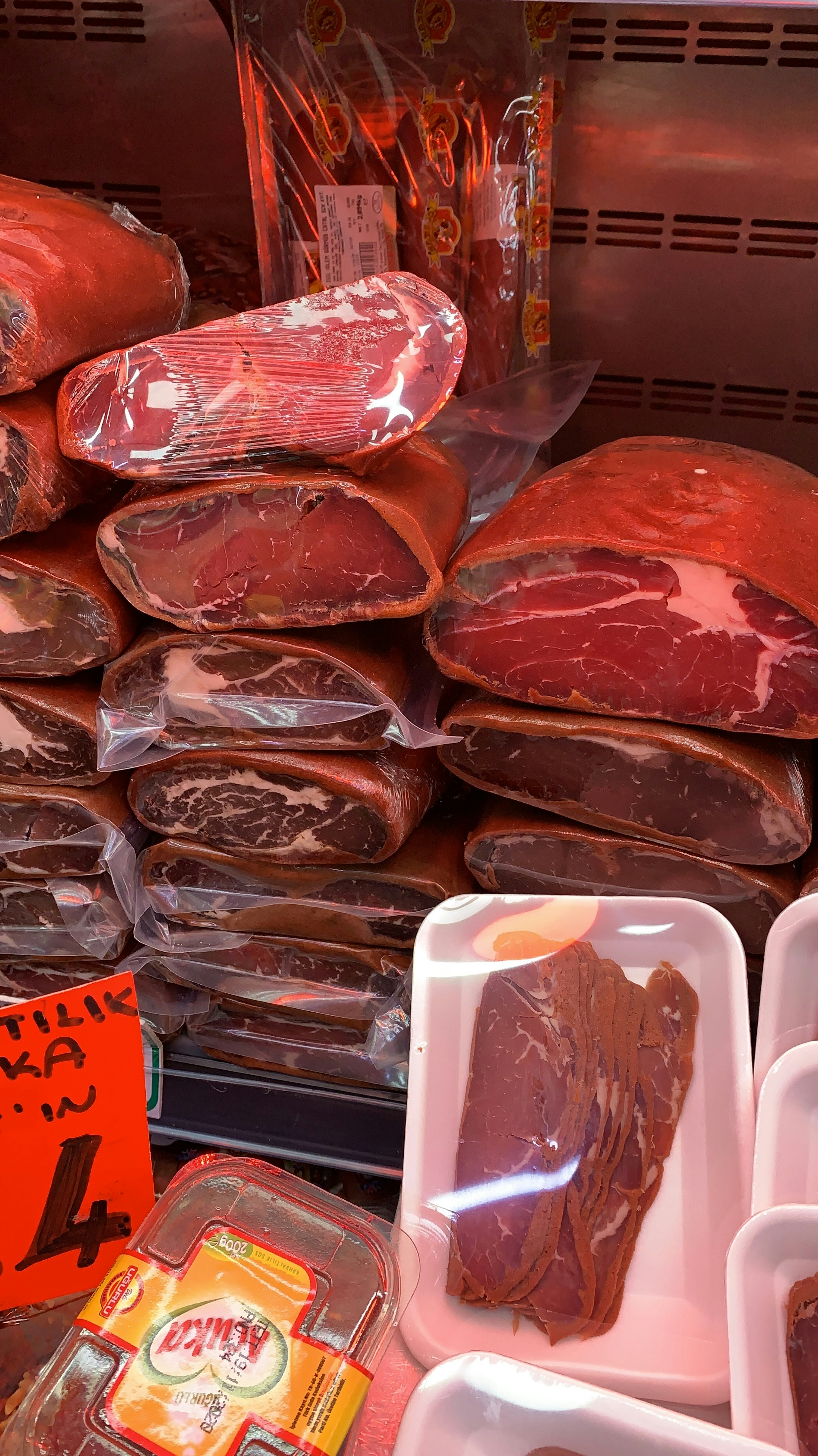 Frozen meat products on dark cold storage background, dim moody atmospheric lighting