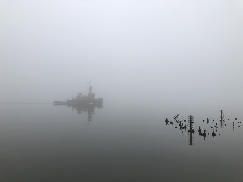 airplane on body of water during foggy weather