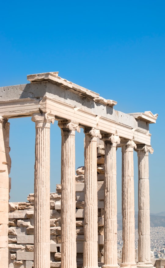 beige concrete pillar under blue sky during daytime in Erechtheum Greece