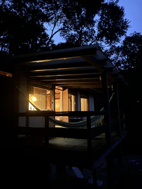 A cozy porch at Koopers Cove with a sunset view over the water.