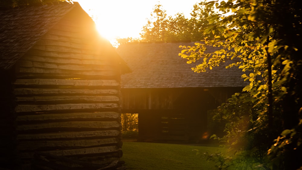 brown wooden house near green trees during daytime