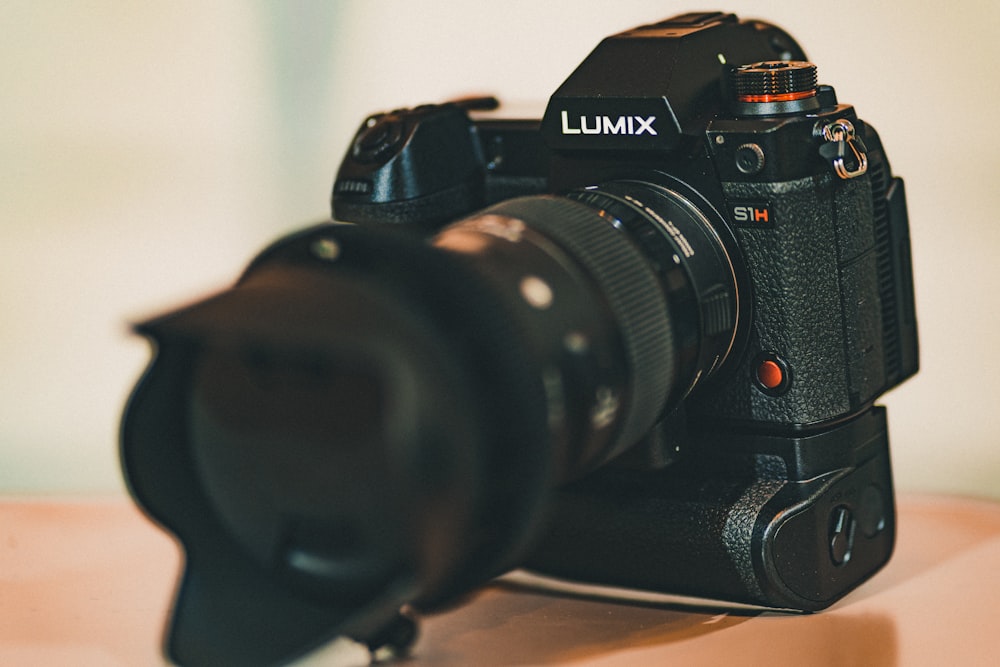 black nikon dslr camera on brown wooden table