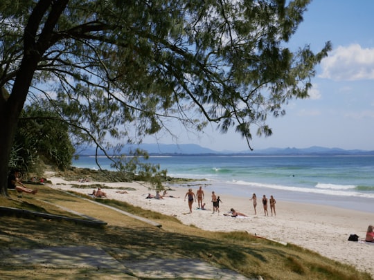 people on beach during daytime in Byron Bay Australia