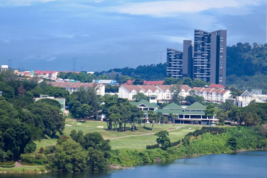 green grass field near body of water during daytime in Selangor Malaysia