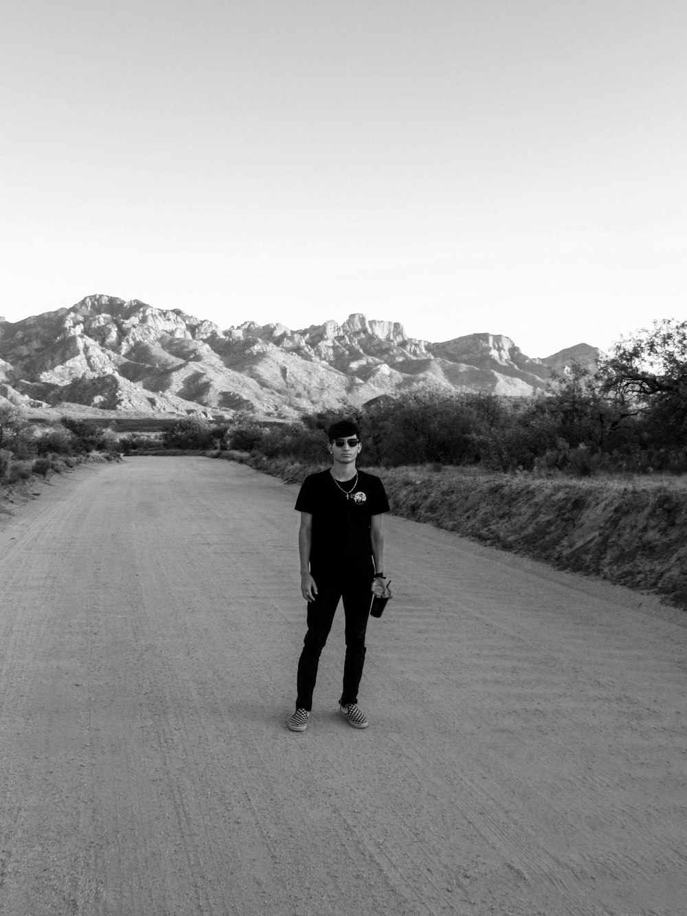 man in black jacket walking on road during daytime