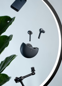 Dynamic shot of Voltex AirPods floating against a black background with glowing red circuitry patterns behind.