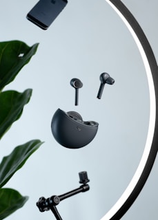 Holobuds floating mid-air with subtle holographic light trails against a dark minimalist background.