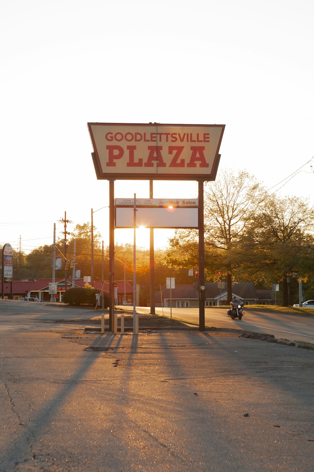 a sign for a pizza place in a parking lot