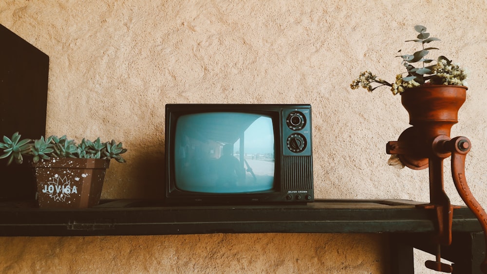 black crt tv on black wooden table