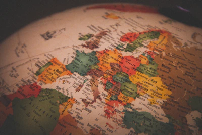 Elegant globe map with golden travel routes connecting continents.