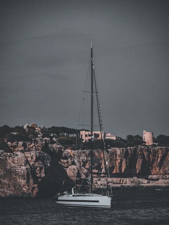 white sailboat on brown rock formation during daytime in Palma Spain