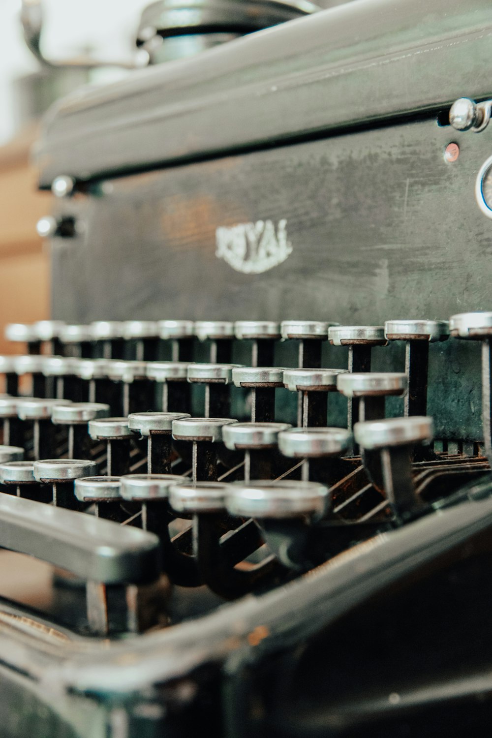 black and silver typewriter on brown wooden table