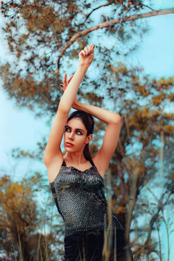A warm, earthy-toned photo of Valerie outdoors in Texas, mid-workout with autumn leaves around.
