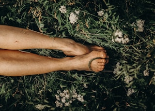 persons feet on white flowers