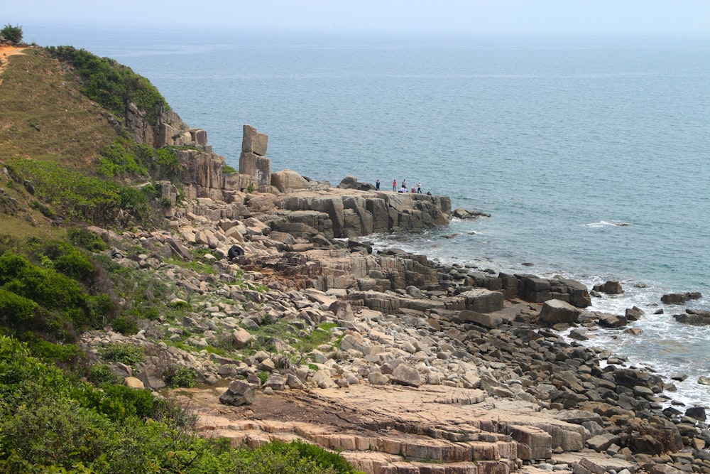 brown rock formation near body of water during daytime